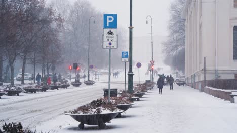 January-Snow-Falling-On-Karl-Johans-Gate-People-Walking-Past-In-Oslo