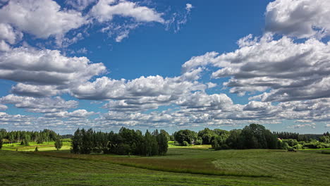 Fluffy-clouds-and-endless-farmland-with-tractor-working,-fusion-time-lapse