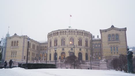 Norwegian-Parliament-Building-In-Oslo-On-Cold-Winter-Day-With-Snow-Falling