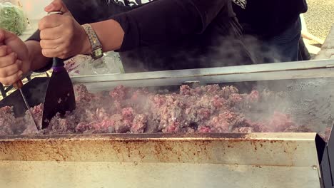 Food-preparation-on-a-metal-surface-with-hand-work