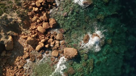 Aerial-high-angle-slow-zoom-in-footage-of-a-beautiful-turquoise-water-near-Rampla-Beach-on-the-Island-of-Gozo,-Malta