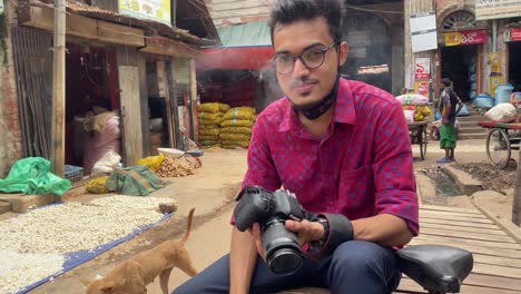 Freelance-photographer-sitting-smoking-travelling-through-Bangladesh