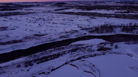 Winter-sunrise-drone-footage-of-the-mountains-and-houses-in-Calgary