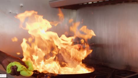 Frying-pan-flames-as-jumbo-shrimps-is-being-cooked-in-the-kitchen-by-a-chef