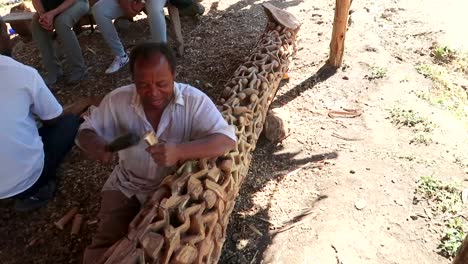 Slow-motion-portrait-of-hardwork-Makonde-tribe-man-making-handmade-wooden-Ujamaa
