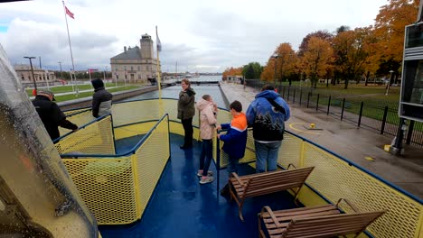 People-on-nose-of-ferry-boat-going-through-Soo-Locks-in-Michigan,-time-lapse-view