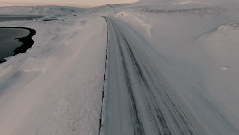 Dolly-forward-above-winter-snowy-road