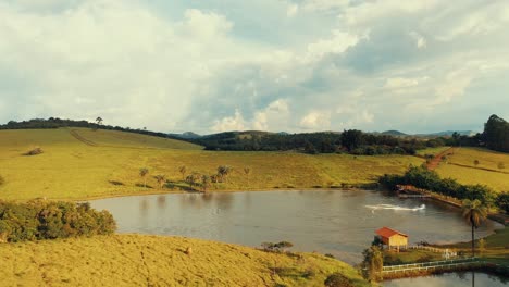 Jet-ski-and-seadoo-cruising-along-a-small-lake-in-the-countryside