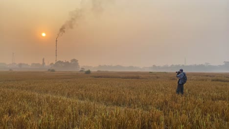 Wide-shot-of-Photographer-documenting-pollution-by-industry-Gas-Plant-area
