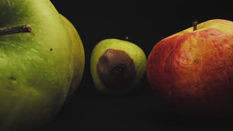 Group-of-aged-apples-and-one-that-is-rotting