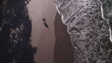 Drone-top-view-of-two-women-jogging-in-the-beach