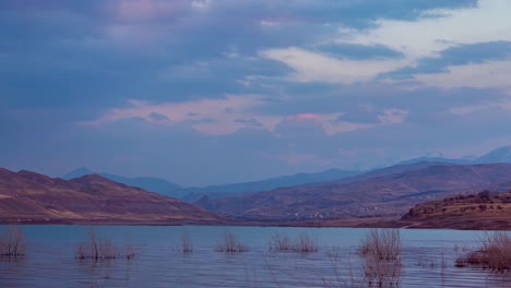 Sunset-time-golden-color-on-lake-and-landscape-of-village-city-town-mountain-hill-and-blue-sky-with-white-clouds-in-travel-to-nature-camp-in-Iran-middle-east-and-enjoy-the-weekend-holiday-time-lapse