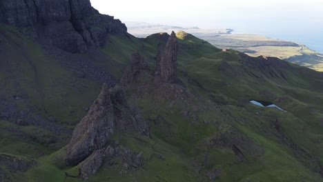 Aerial-dolly-overhead-standalone-rock-formations-at-the-Old-Man-of-Storr,-Isle-of-Skye