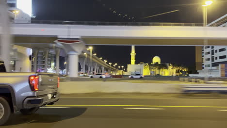 GMC-Truck-driving-on-the-Dubai-suburb-highway-at-night,-side-view