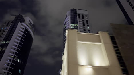 Toma-De-Paralaje-De-Un-Edificio-En-La-Ciudad-De-Dubai-Por-La-Noche