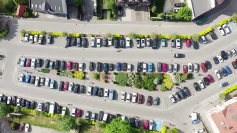 Aerial-top-down-steady-view-of-city-car-parking-with-many-cars-from-above-in-an-old-European-city-centre-4K