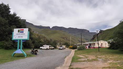 Having-descended-rugged-Sani-Pass,-vehicles-stop-at-ZA-border-control