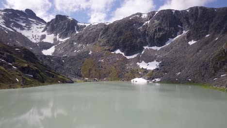 Drone-shot-of-a-glacial-lake-up-in-Alaska's-Hatcher-Pass
