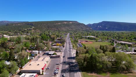 Aerial-View-Over-Main-Road-in-Durango,-Colorado-with-Cars-Passing-During-Summer