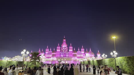 Wide-view-with-people-walking-to-the-entrance-in-the-Global-village-in-Dubai-at-night