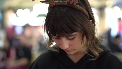 Close-up-of-a-girl's-face-as-she-concentrates-to-write-a-Christmas-letter-at-a-local-market