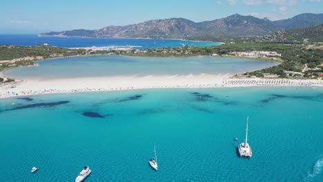 Porto-Giunco-Beach-in-Villasimius,-Sardinia,-Italy---Turquoise-Blue-Mediterranean-Sea-and-Salt-Lake---Aerial-4k