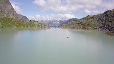 Drone-shot-of-a-tourist-floating-in-an-Alaskan-glacial-lake
