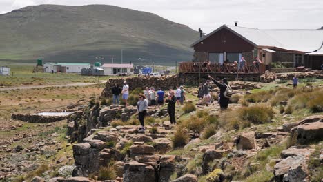 Tourists-visit-lodge-at-top-of-rugged-Sani-Pass-in-Lesotho,-Africa