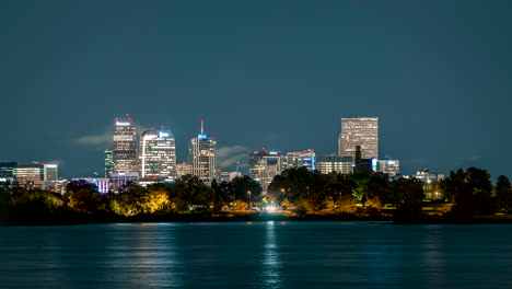 Time-lapse-of-clouds-passing-over-Denver's-downtown-skyscrapers-at-night-with-Sloan-Lake-prominently-in-the-foreground