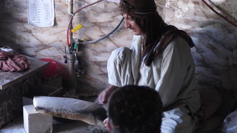 Male-Baker-Placing-Naan-Bread-Into-Tandoor-Oven-In-Local-Shop-In-Quetta,-Pakistan