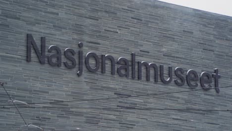 Close-Up-View-Of-Nasjonalmuseet-Sign-Lettering-During-Snowfall-In-Oslo,-Norway