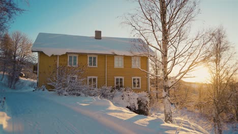 Norwegian-Apartment-in-snowy-mountains-of-Valdress-during-golden-sunset-in-winter---static-wide-shot