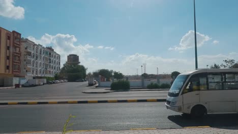 Hurghada,-Egypt-29-December-2022,-Daytime-City-View-Through-the-Bus-Window,-Traffic,-Houses,-Architecture,-People