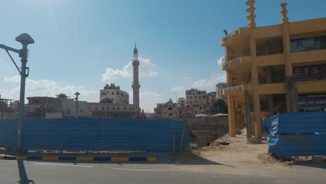 Hurghada,-Egypt-29-December-2022,-Daytime-City-View-Through-the-Bus-Window,-Traffic,-Houses,-Architecture,-People