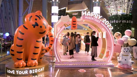 People-enjoy-their-time-at-a-Chinese-New-Year-installation-event-at-a-shopping-mall-head-of-the-upcoming-Lunar-Chinese-New-Year-in-Hong-Kong