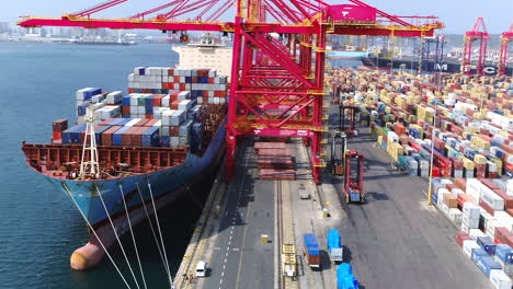 Aerial-drone-over-a-large-container-ship-being-loaded-by-gantry-cranes-in-Durban-harbour