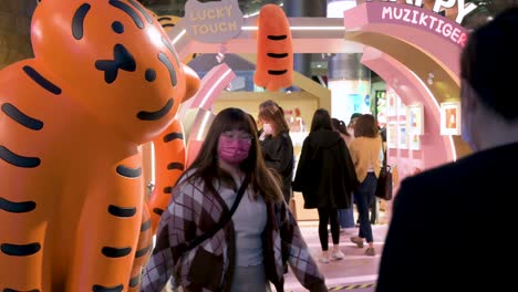 People-have-their-photos-taken-at-a-Chinese-New-Year-installation-event-at-a-shopping-mall-head-of-the-upcoming-Lunar-Chinese-New-Year-in-Hong-Kong