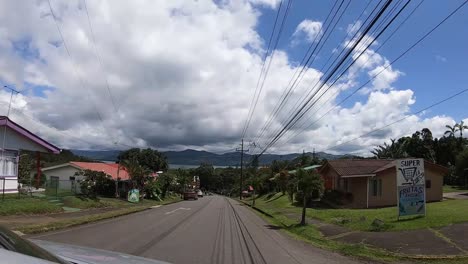 Driving-on-a-road-overlooking-the-Arenal-Volcano-lake,-Costa-Rica