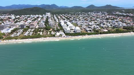 Aerial-drone-scene-at-high-altitude-of-luxurious-beach-seaside-town-in-Florianopolis-beach-town-planning-with-many-houses-and-apartments-facing-the-sea-in-Jurere-Internacional-Florianopolis