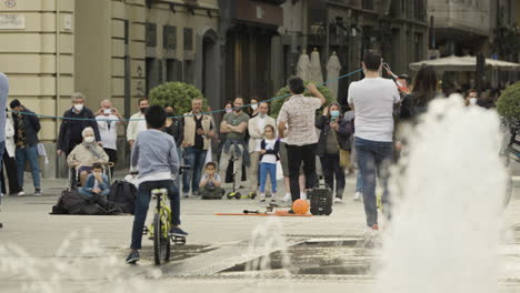 Wide-shot-of-a-street-performer-entertaining-crowd