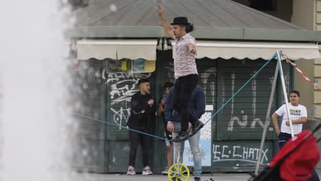 A-street-performer-entertaining-a-crowd-with-a-water-fountain-in-the-foreground