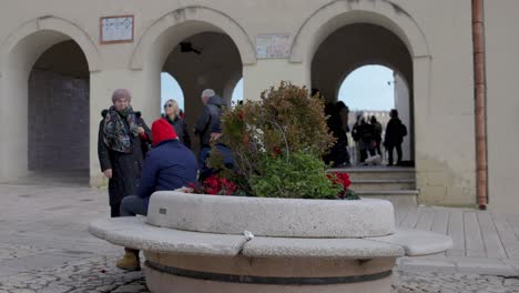 Matera,-Italy-market-area-with-bench-and-people-walking-around