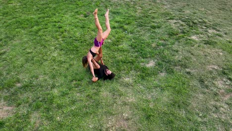 Couple-practicing-acro-yoga-in-white-studio