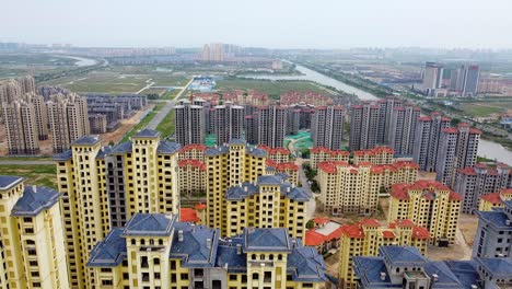 Aerial-drone-view-of-empty-skyscraper-apartments-in-Nanhai-New-district,-China