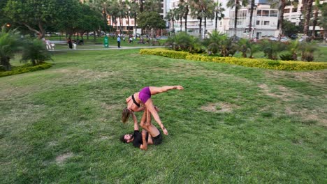 Couple-practicing-acro-yoga-in-white-studio