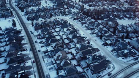 Drone-footage-of-Calgary's-houses-covered-with-snow-during-a-beautiful-winter-sunrise