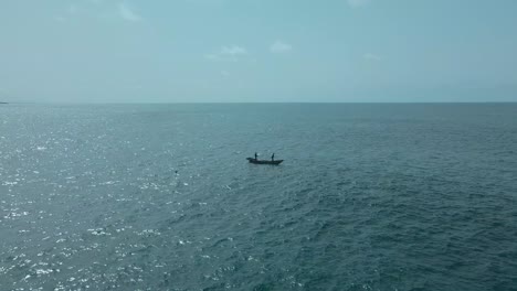 Victoria-Island-Lagos,-Nigeria---20-November-2022:-Drone-view-of-a-fisherman-on-a-fishing-boat-on-the-coastline-of-Lagos