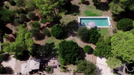 Aerial-dolly-shot-showing-people-relaxing-in-the-mansions-private-pool-in-southern-France