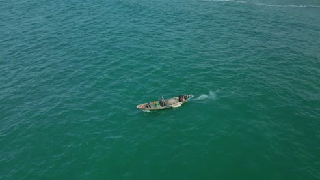 Victoria-Island-Lagos,-Nigeria---20-November-2022:-Drone-view-of-a-fisherman-on-a-fishing-boat-on-the-coastline-of-Lagos