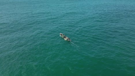 Victoria-Island-Lagos,-Nigeria---20-November-2022:-Drone-view-of-a-fisherman-on-a-fishing-boat-on-the-coastline-of-Lagos